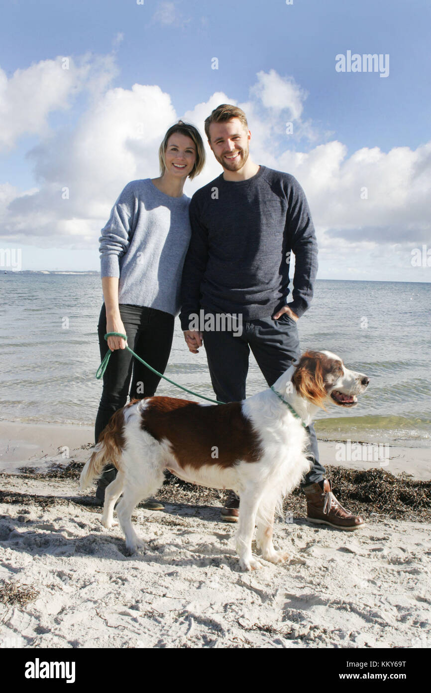 Coppia con passeggiata con i cani sulla spiaggia del Mar Baltico, Foto Stock