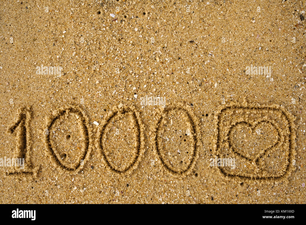 Pulsante come 1.000 del tempo come un disegno sulla sabbia. Foto Stock