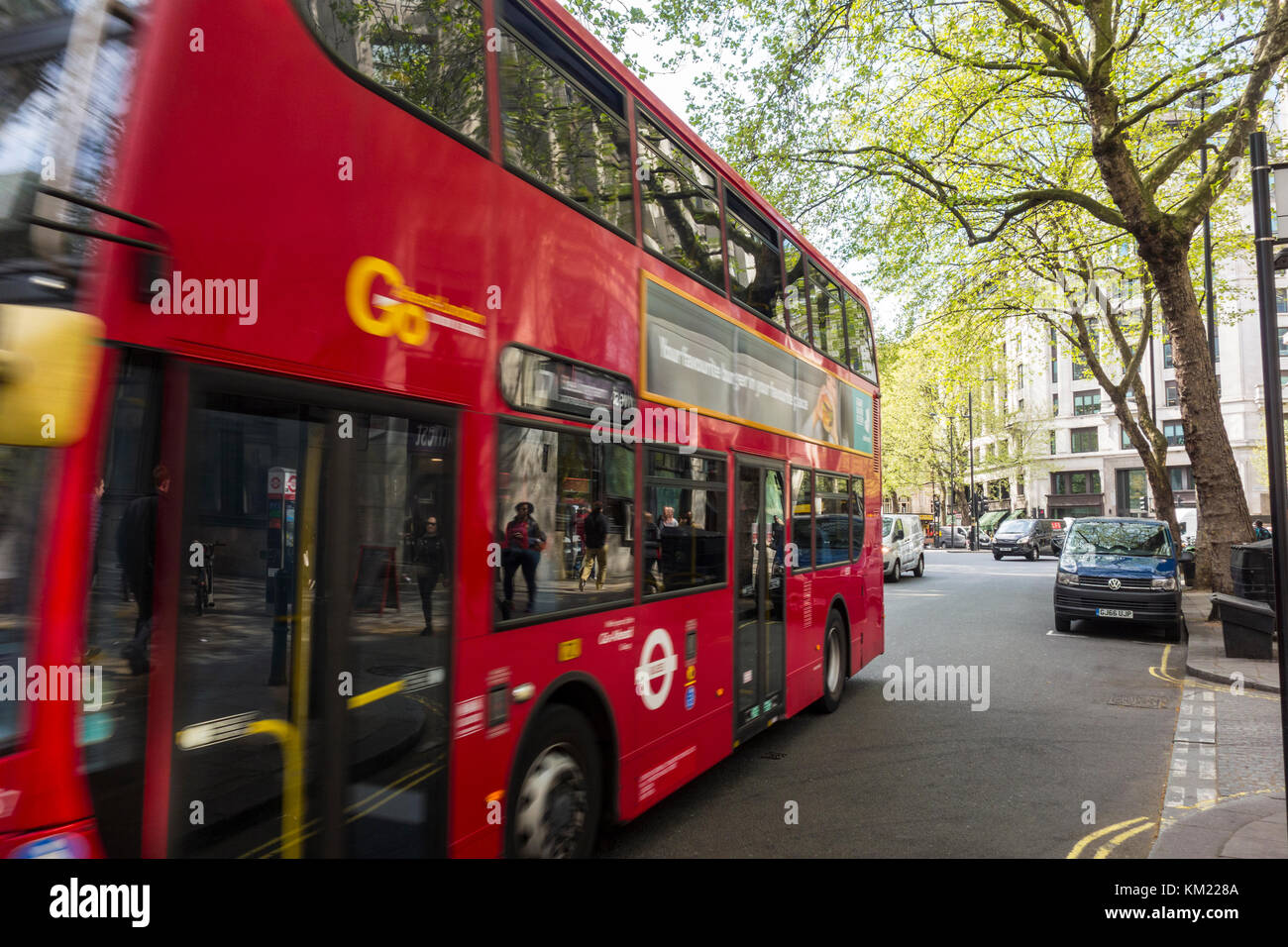 Riflessioni di persone sul marciapiede in un rosso di autobus di Londra, Regno Unito Foto Stock