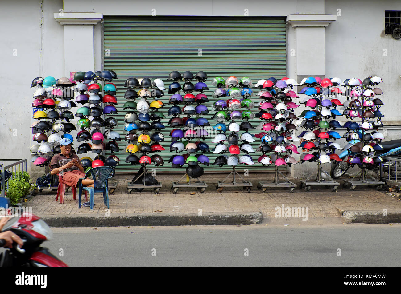 Ho chi minh city, il Viet Nam e colorati di caschi all aria aperta shop, casco motorcycle show sul marciapiede di strada urbana, a basso costo e bassa qualità Foto Stock