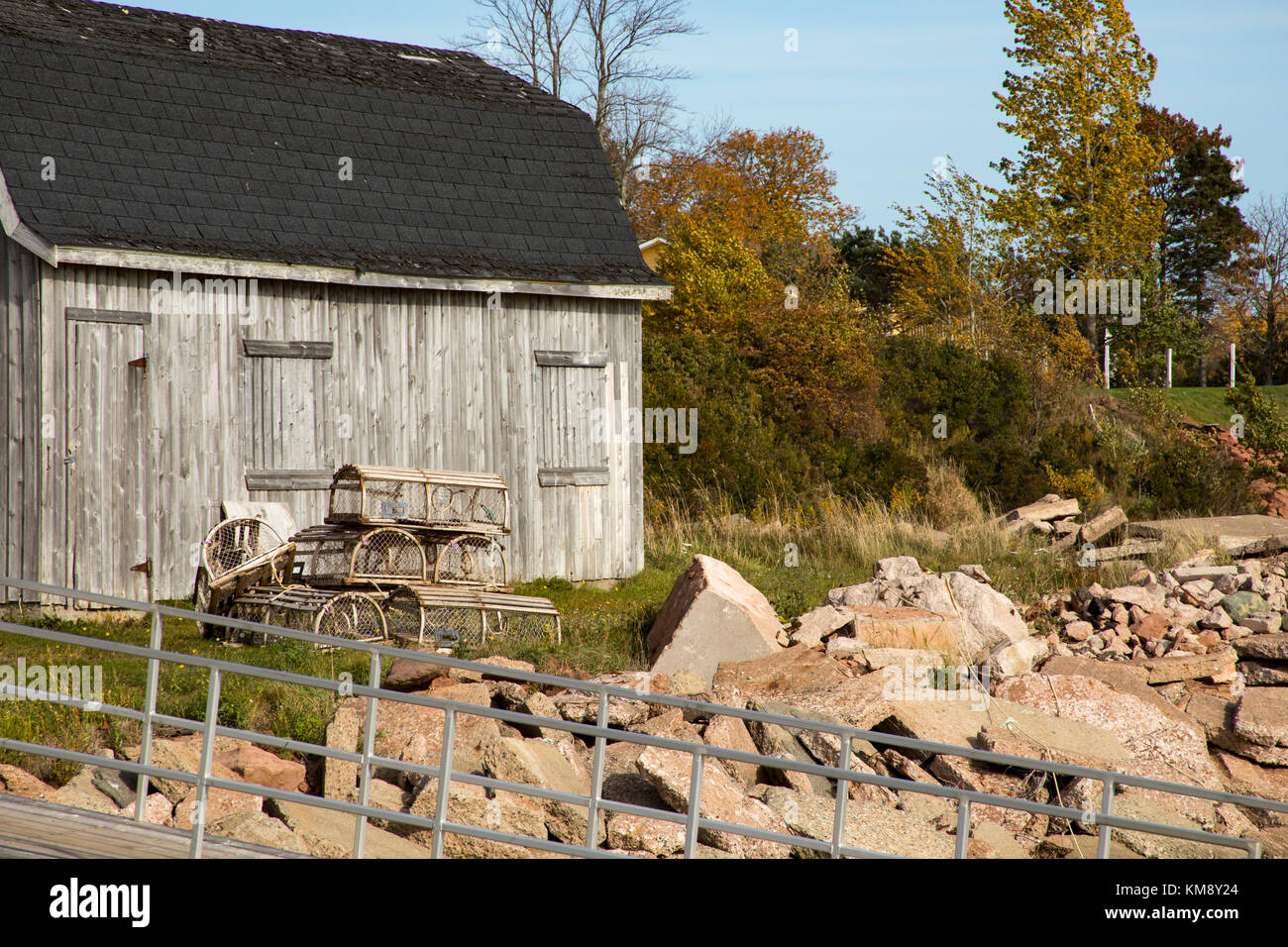 Legno trappole di aragosta fuori baracche di pesca nel porto di Georgetown, PEI, Canada sulla soleggiata giornata di caduta. Foto Stock
