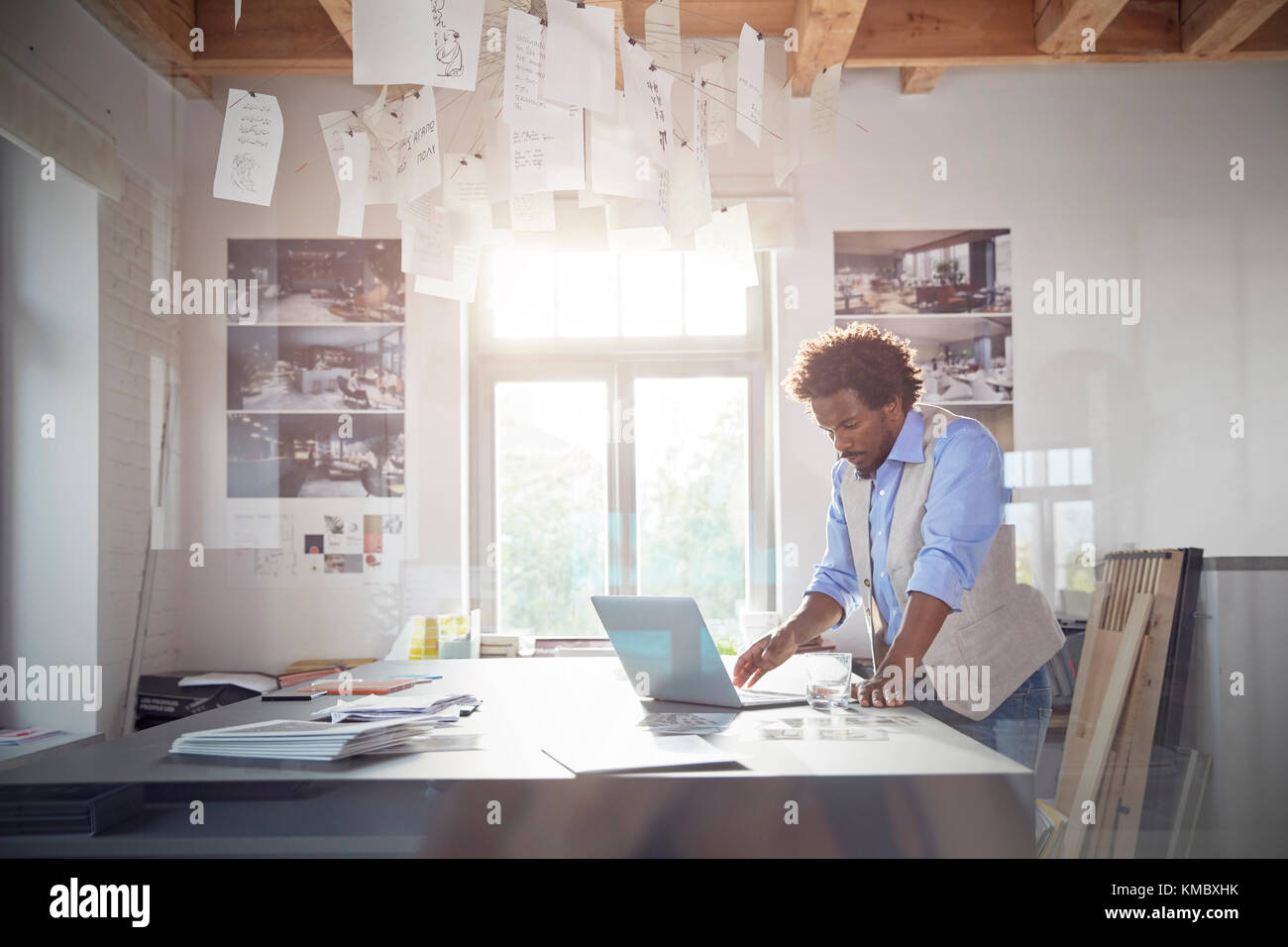 Maschio di graphic designer che lavora al computer portatile in ufficio Foto Stock