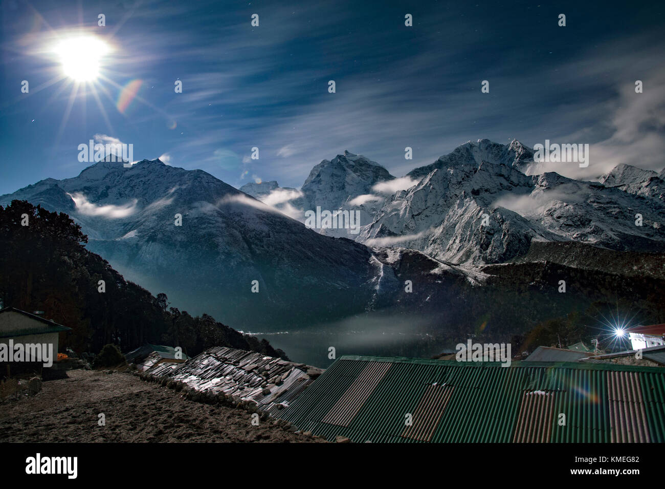 Sole che splende su villaggio rurale e montagne innevate, Solukhumbu, Nepal Foto Stock