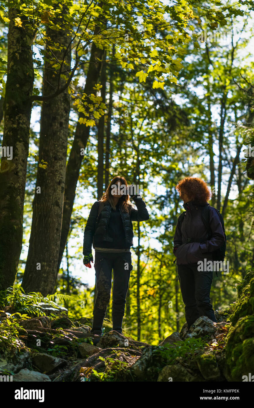 Amiche in vacanza escursioni in un canyon remoto coperte di muschio e vegetazione lussureggiante Foto Stock