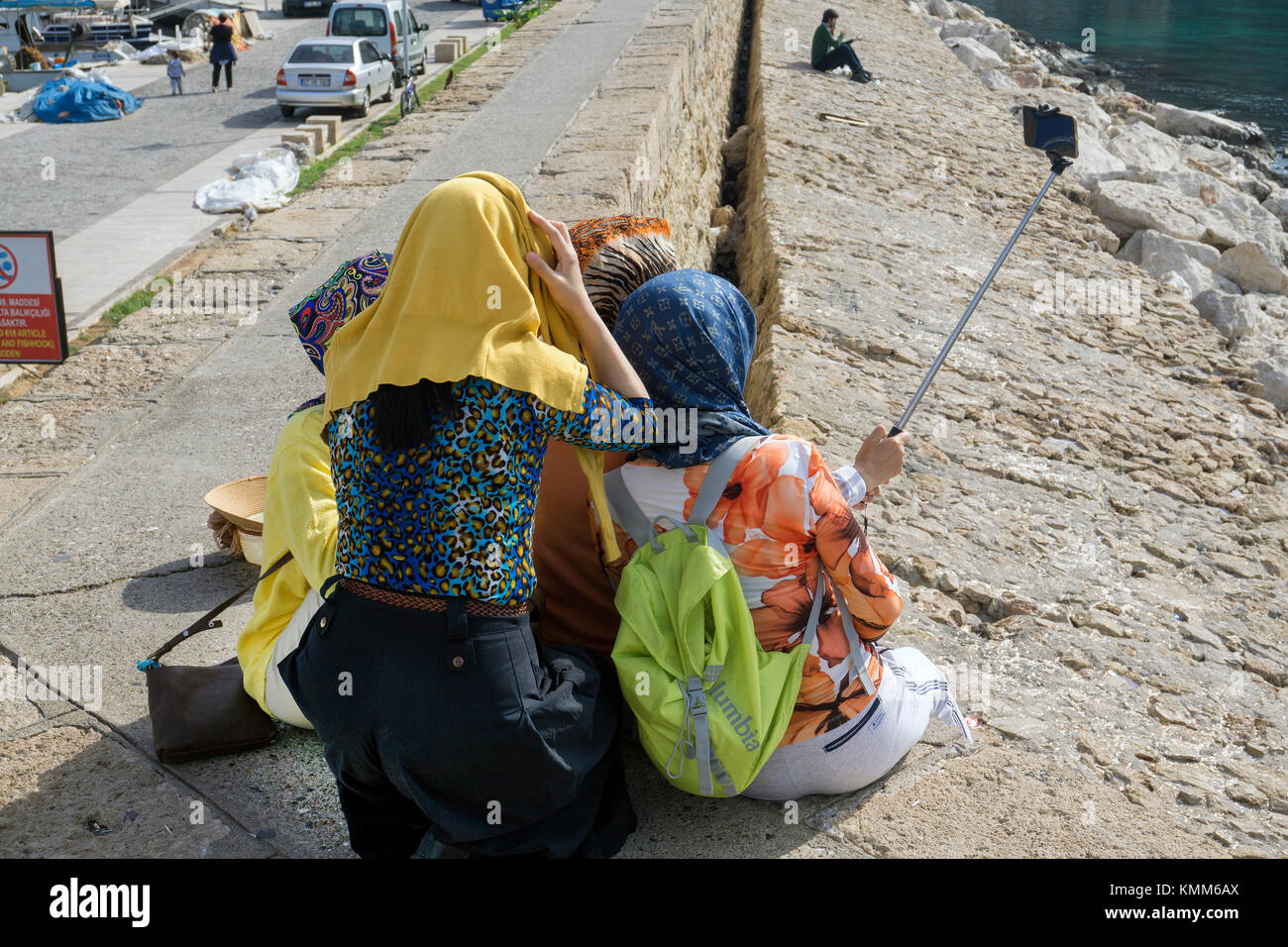 Bagno turco ragazze con headscarfs fotografando un selfie, porto di Kaleici, la città vecchia di Antalya, riviera turca, Turchia Foto Stock