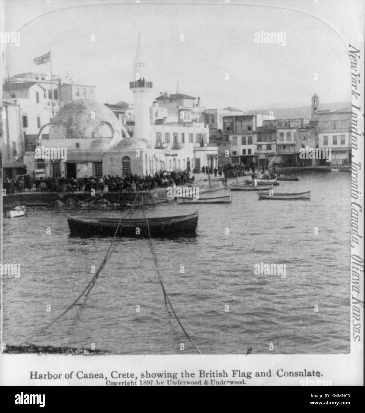 Una fotografia storica del porto di Canea a Creta, che mostra la bandiera britannica e il Consolato britannico. Questa immagine evidenzia l'influenza coloniale nella regione durante il periodo dell'amministrazione britannica. Foto Stock