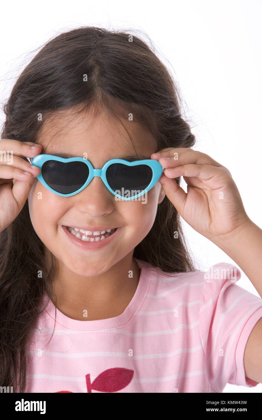 Bambina indossa a forma di cuore ad occhiali da sole Foto stock