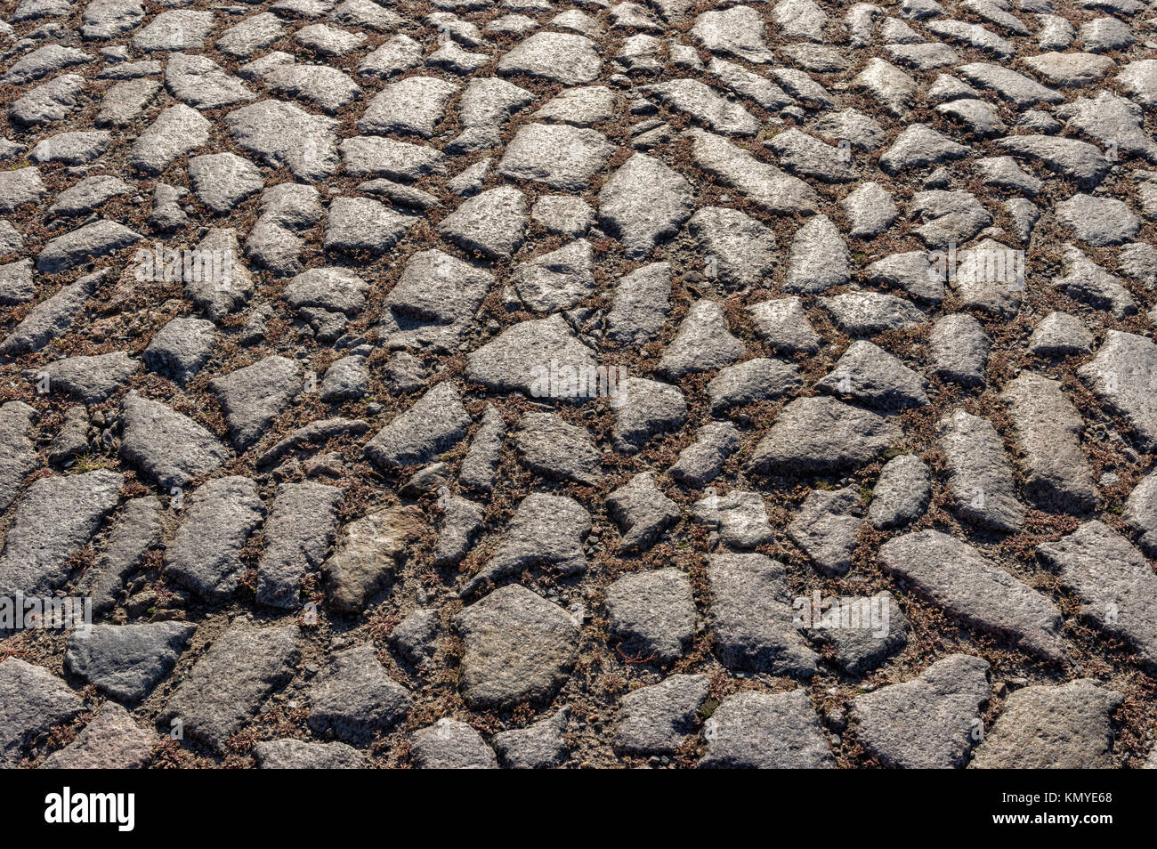 Superficie di una vecchia strada acciottolata Foto Stock