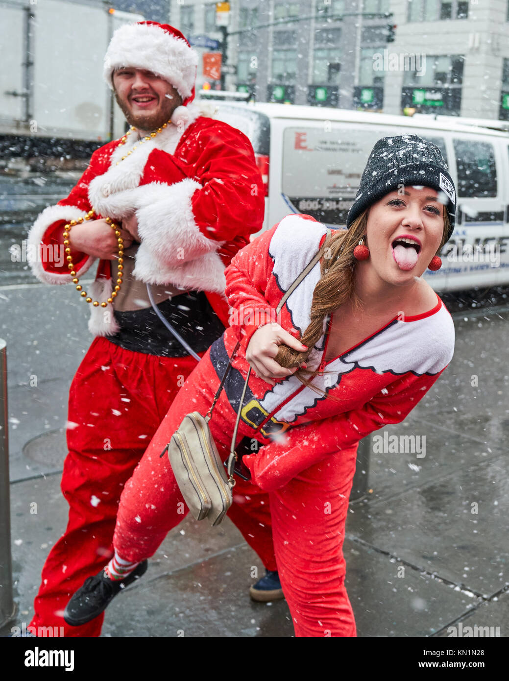 New York, Stati Uniti d'America, 9 Dic 2017. Persone che indossano il Natale-relativi costumi hanno divertimento sotto una tempesta di neve in una festosa 'Santacon' folla raccolta. Foto di Enrique Shore/Alamy Live News Foto Stock
