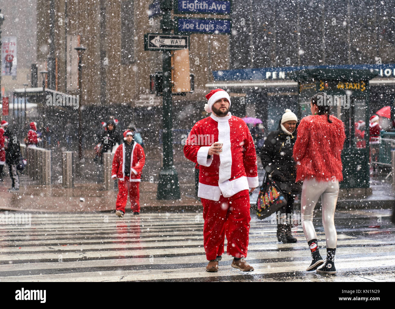 New York, Stati Uniti d'America, 9 Dic 2017. La gente vestita come Babbo Natale arriva per una festosa 'Santacon' folla raccolta sotto una tempesta di neve. Foto di Enrique Shore/Alamy Live News Foto Stock