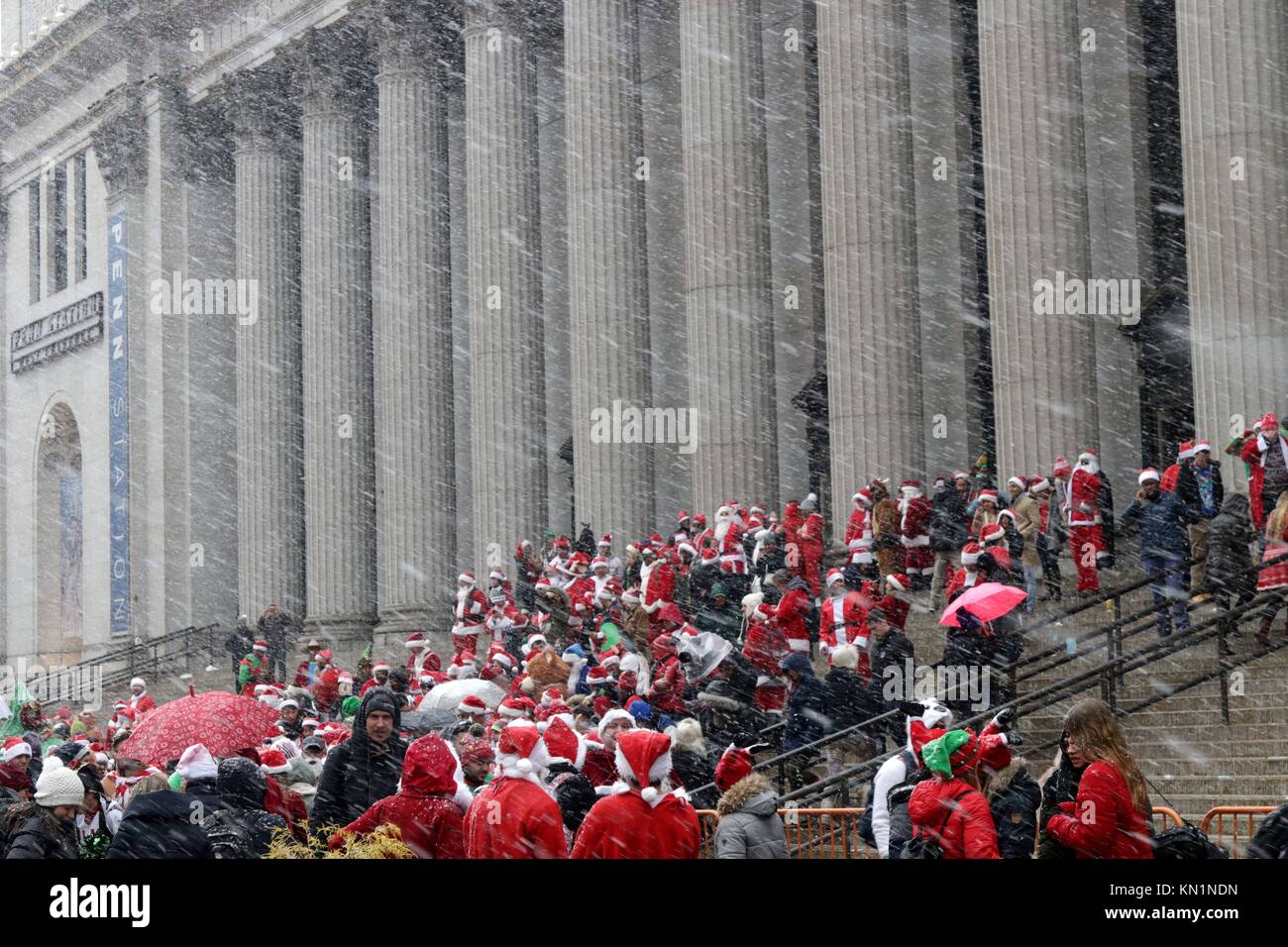 New York, NY, USA. 9th. Dic, 2017. Inizio a Copenaghen nel 1974, il pub crawl che ogni anno attirano migliaia di Santa-placcati revealers, arrivati negli Stati Uniti in 1994 ed è diventato il più grande pub crawl in tutto il mondo dal 1998 con la sua New York arrivo. Migliaia, sotto la prima neve giorno del 2017 stagione invernale si sono riuniti presso il punto di adunata in New York City, prima dell invasione di Babbo Natale ha iniziato la città-ampia ricerca per indicizzazione. © 2017 G. Ronald Lopez/DigiPixsAgain.us/Alamy Live News Foto Stock