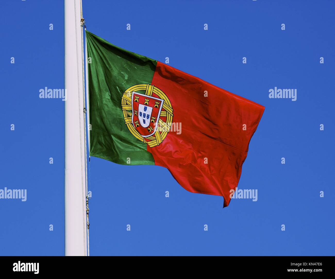 Nazionale Portoghese battenti bandiera contro il cielo blu, Lisbona, Portogallo, Europa occidentale. Foto Stock