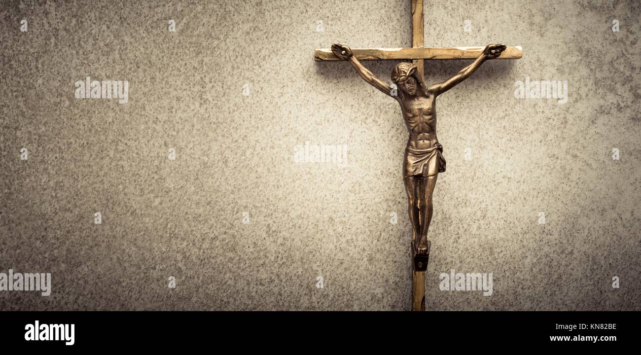 Crocifisso di Gesù sulla croce con la pietra di sfondo. Simbolo della religione cristiana e la fede. Immagine composta con copia spazio. Foto Stock