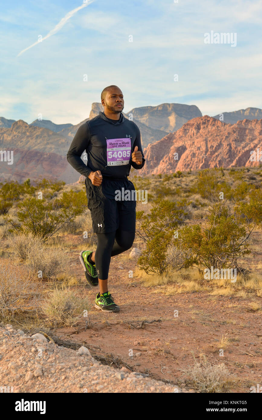 African American uomo formazione per 10k correre nel deserto del Nevada. Foto Stock