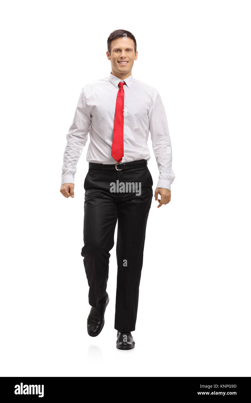 A piena lunghezza Ritratto di un elegante ragazzo cammina verso la telecamera isolata su sfondo bianco Foto Stock