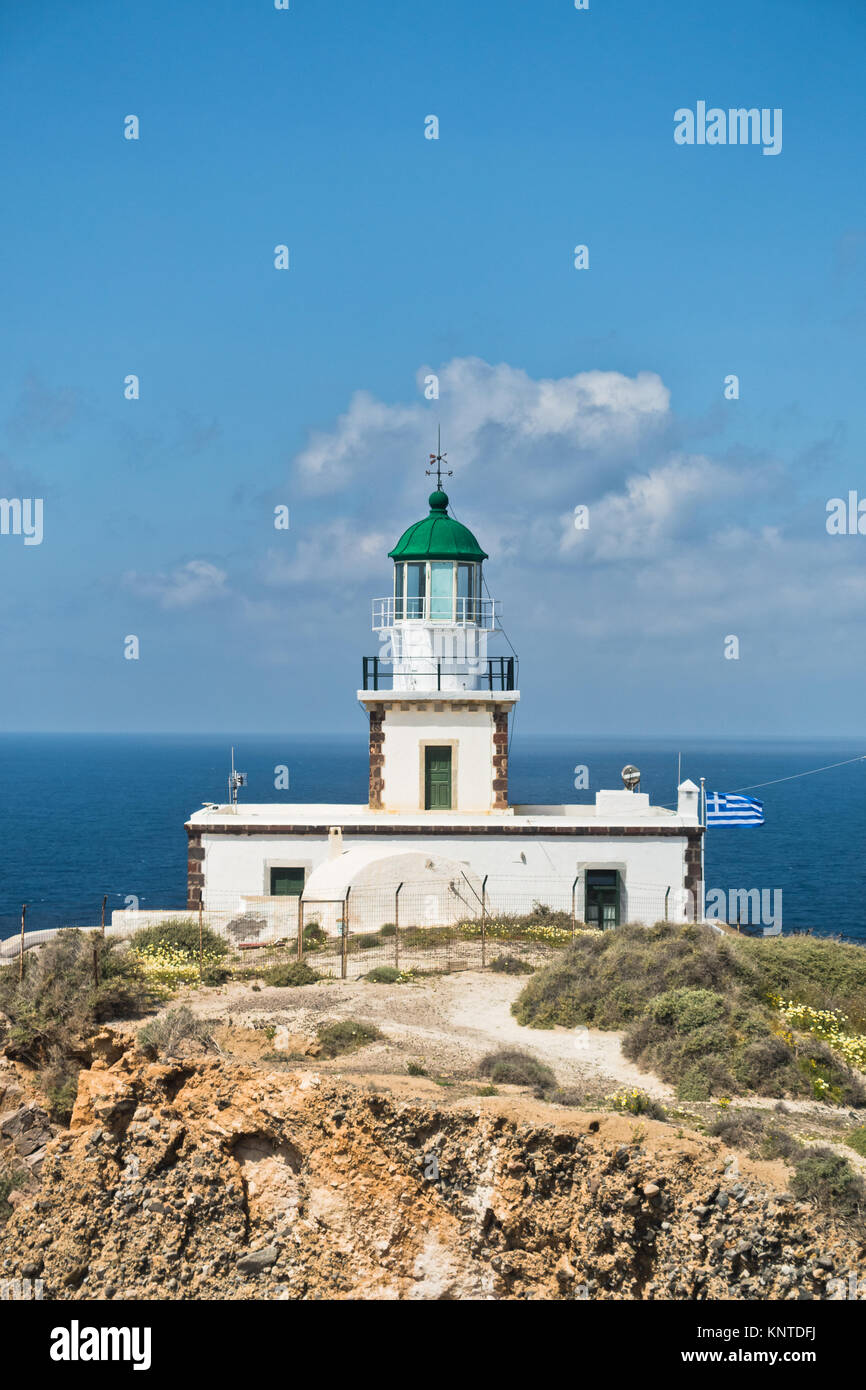 Faro di Akrotiri a mattina di sole con pittoresche nuvole, isola di Santorini Foto Stock