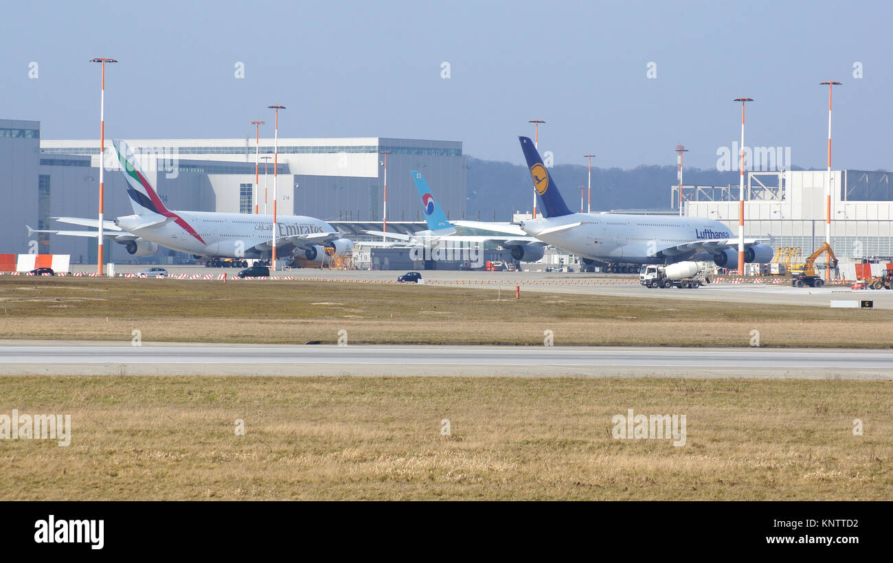 Amburgo, Germania - 7 marzo 2014: Un Emirates e Lufthansa A380 piano vengono montati nella parte anteriore della pianta di Airbus di Amburgo Finkenwerder Foto Stock