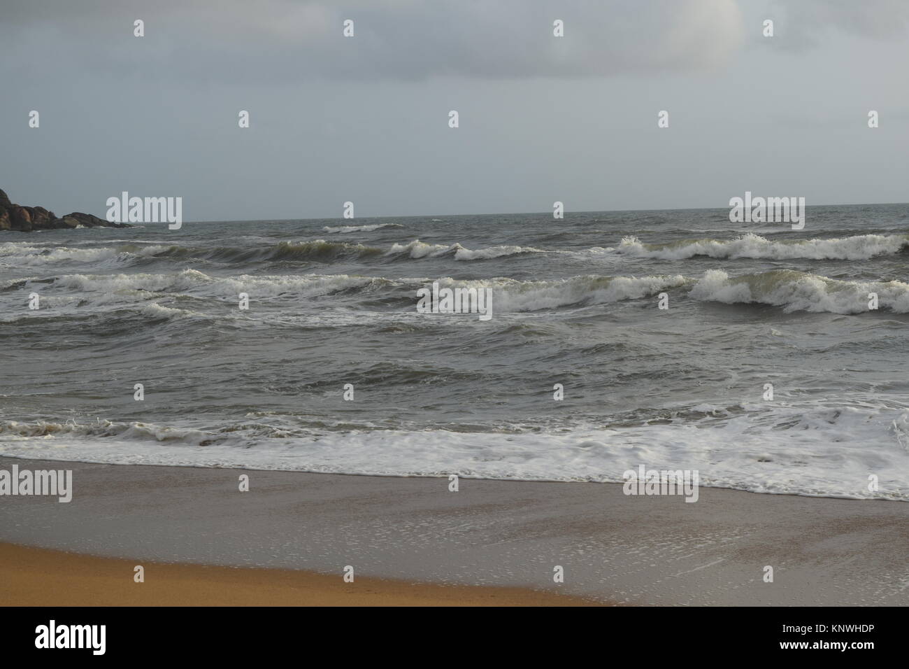 Spiaggia di sabbia di immagini su un giorno nuvoloso. Raffreddare la spiaggia con nessun popolo. Bellissima spiaggia sfondo per sito web o desktop. Mare / oceano / spiaggia vista. Foto Stock