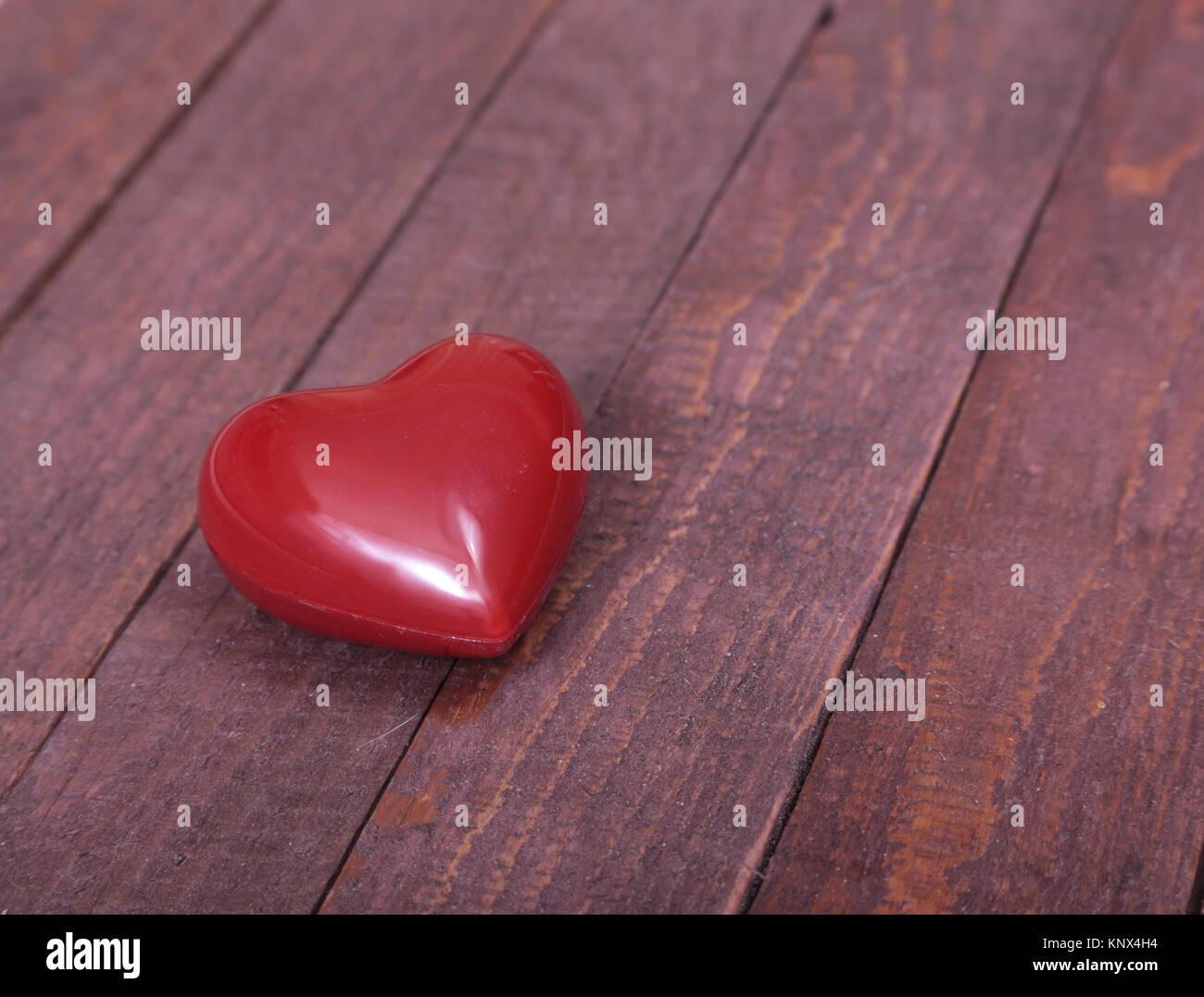 Splendido cuore rosso isolato su sfondo di legno Foto Stock
