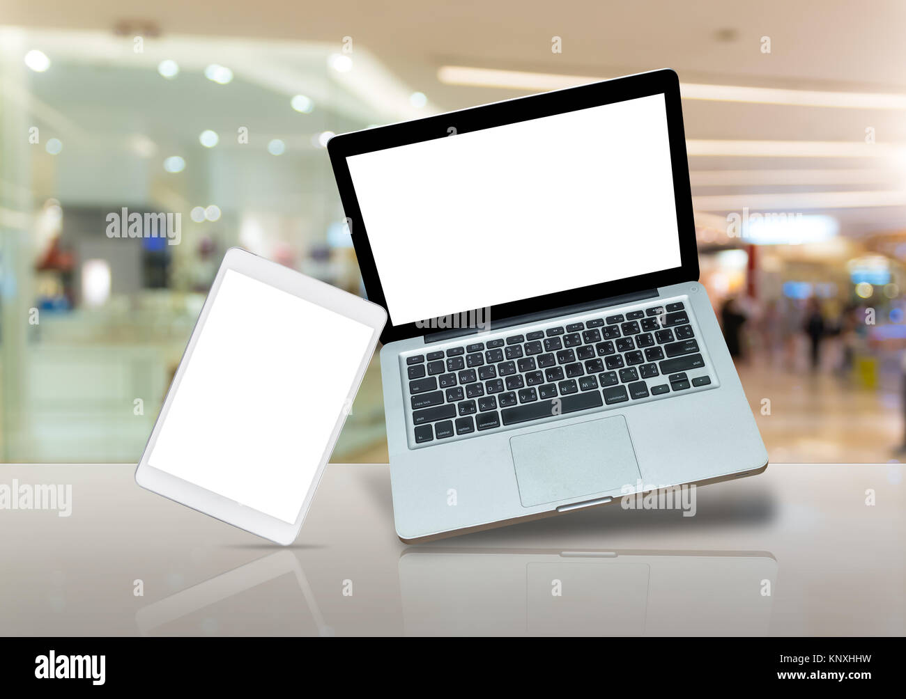 Laptop e tablet pc sul tavolo su store la sfocatura dello sfondo con bokeh, business concetto tecnologico Foto Stock
