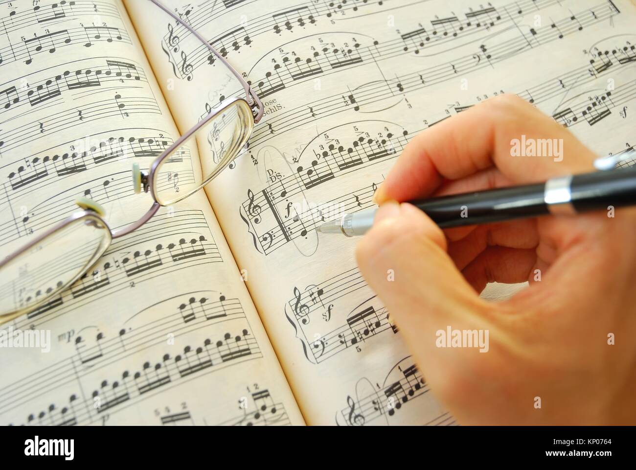 Scrittura su uno spartito. Per concetti come la composizione di musica e creatività. Foto Stock