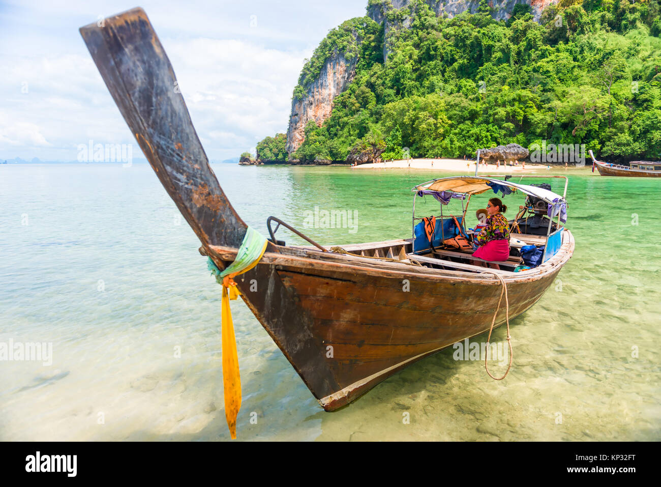 I turisti in un mare a piedi su una tradizionale barca Thai long tail in Thailandia Foto Stock