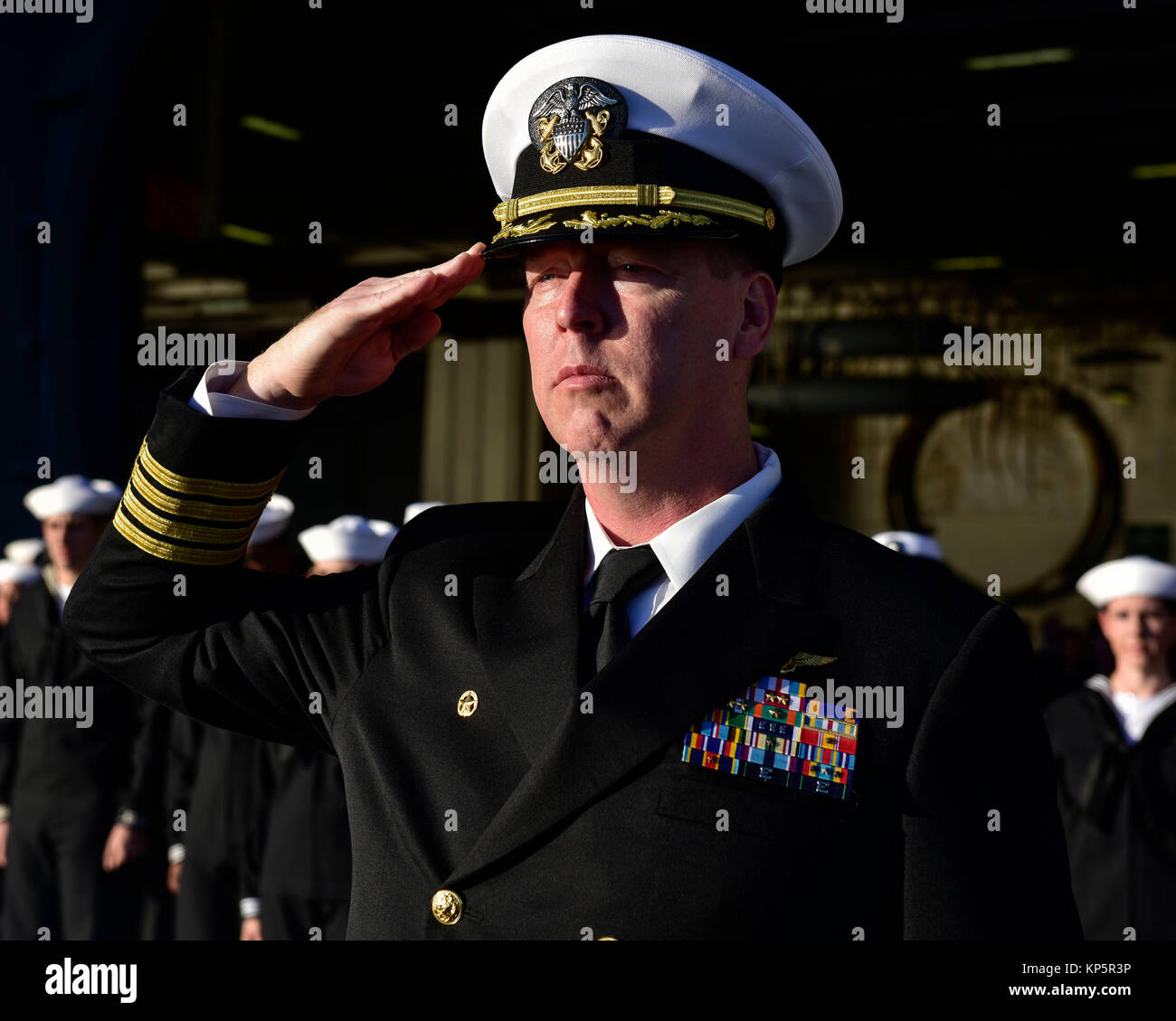 Stati Uniti Navy Comandante Kevin Lenox rende un saluto durante la sepoltura in mare a bordo della U.S. Nimitz Navy-class portaerei USS Nimitz Dicembre 6, 2017 nell'Oceano Pacifico. (Foto di Emily Johnston via Planetpix) Foto Stock