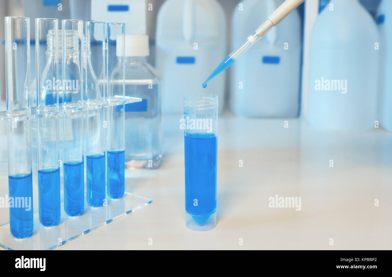 Background scientifico in blu e bianco. Il campione di liquido il caricamento con pipetta automatica, lo spazio per il tuo testo. Questa immagine è tonica. Foto Stock