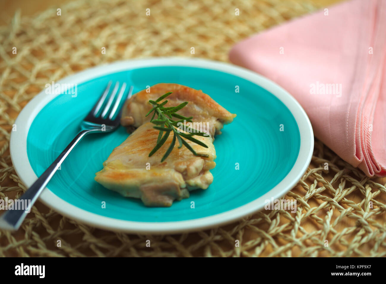 Il pollo cotto in padella con olio di oliva e il rametto di rosmarino Foto Stock