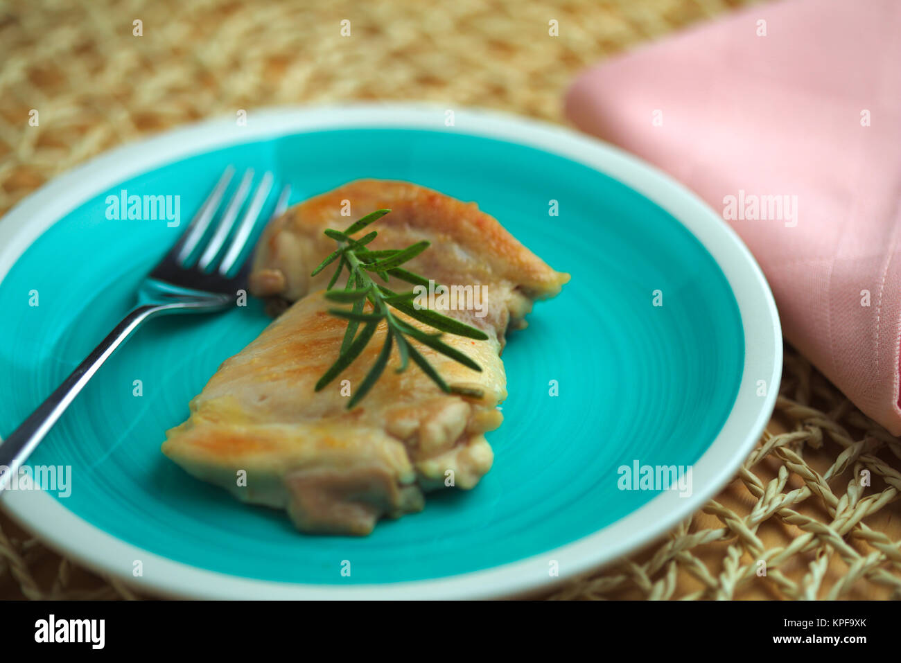 Il pollo cotto in padella con olio di oliva e il rametto di rosmarino Foto Stock