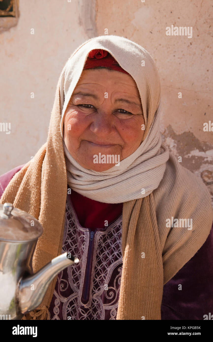 La Tunisia, Ksour Area, Metameur, di mezza età donna tunisino che serve tè (MR) Foto Stock