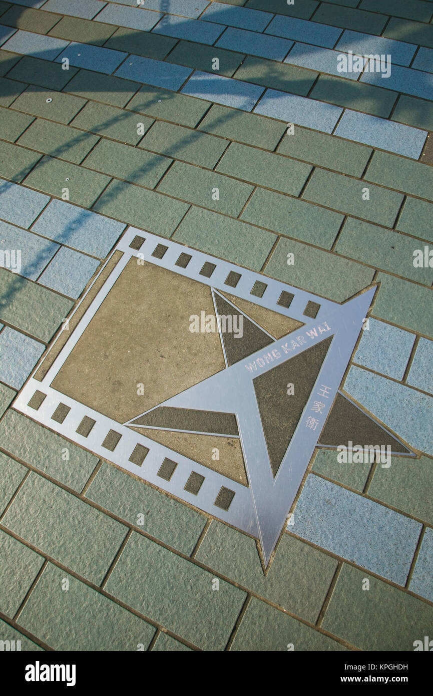Cina, Hong Kong. Kowloon, Viale delle Stelle dal Victoria Harbour, placca e Handprints di Wong Kar Wai, direttore. Foto Stock