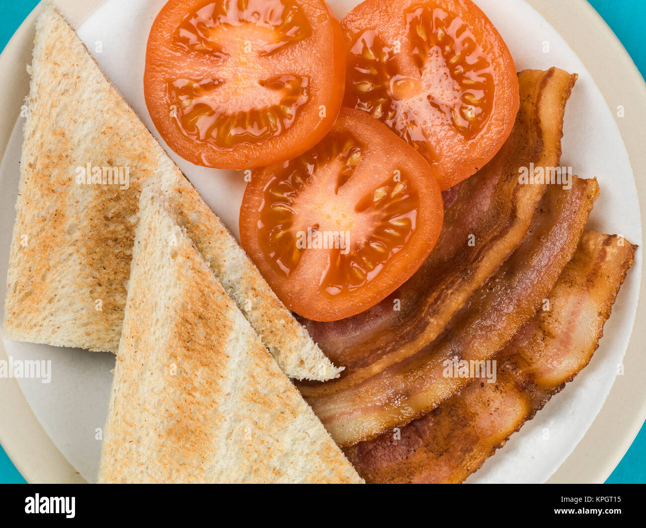 La pancetta e pomodoro con Toast contro uno sfondo blu Foto Stock