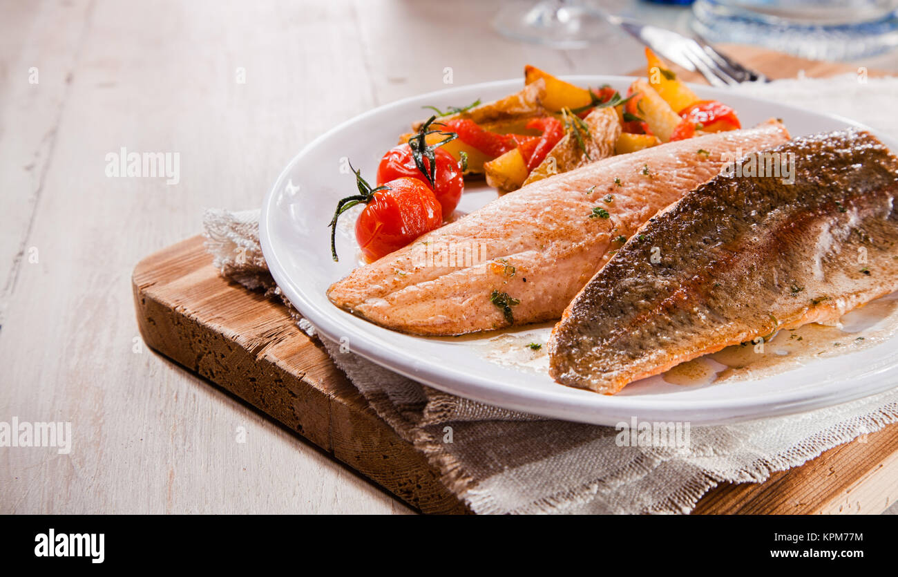 Due gustosi salmone alla griglia con i filetti di trota con copia spazio con verdure su piastra vintage per ristoranti di pesce Foto Stock