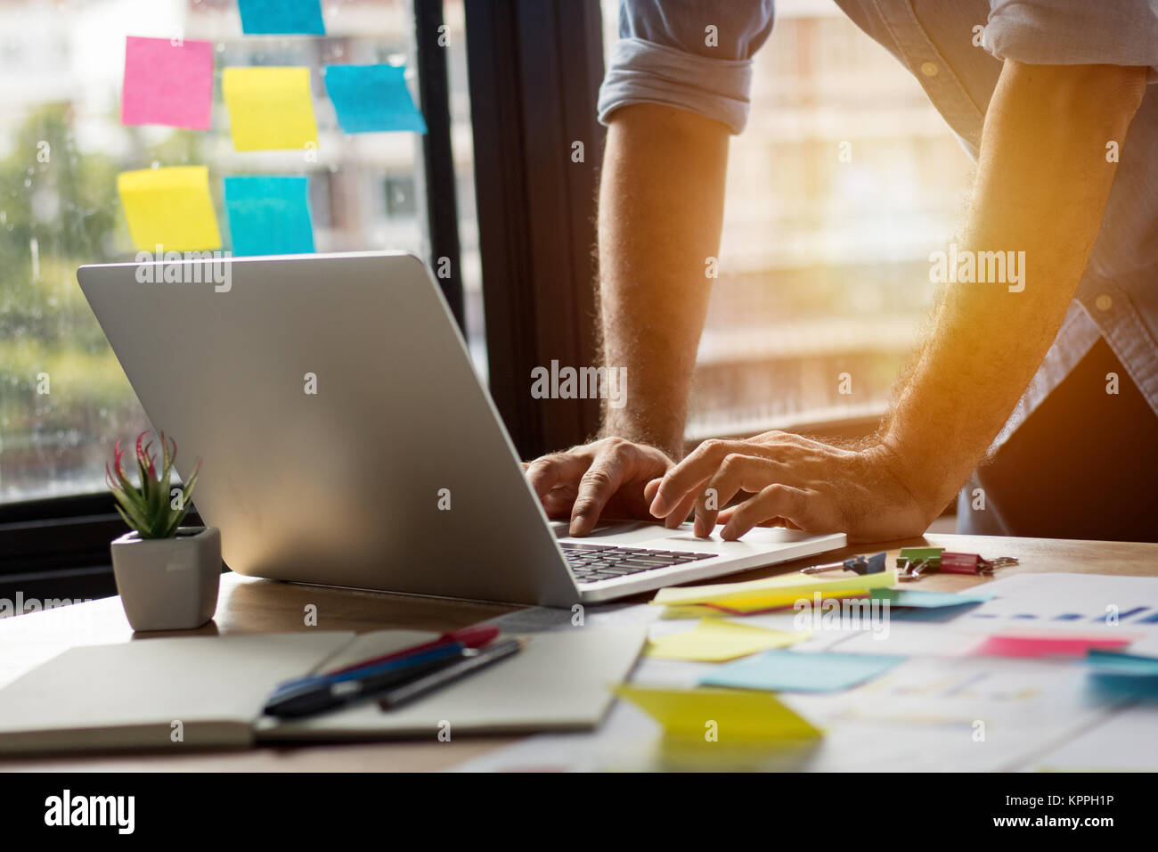 Il collegamento e il concetto di tecnologia, l'uomo utilizza computer portatile in ufficio con grafico carta business e piallatura e lavoro sulla scrivania Foto Stock