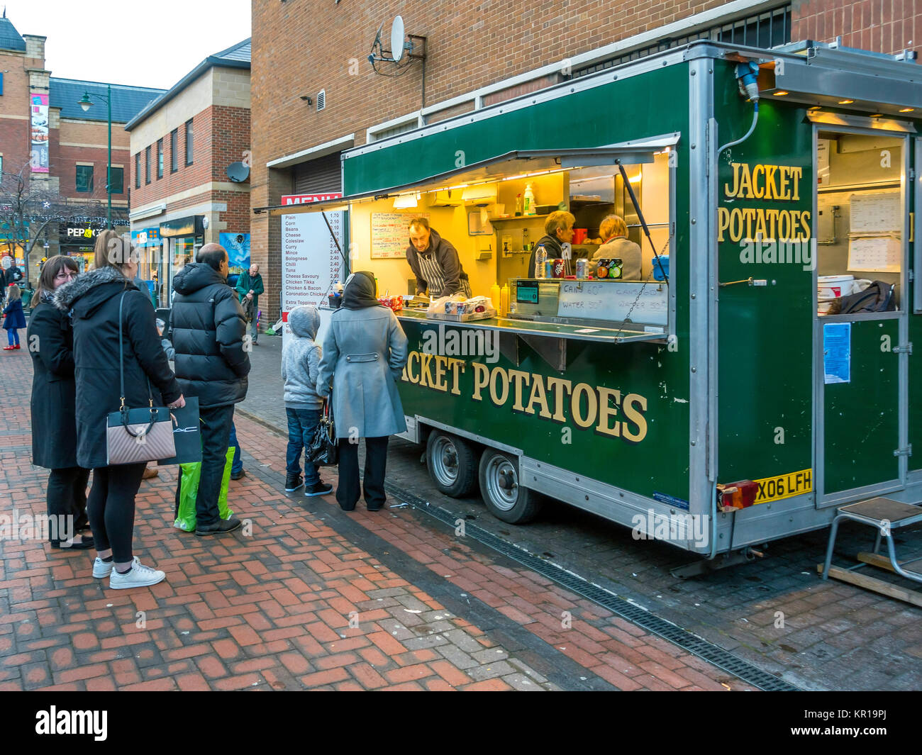 Una coda di persone che acquistano prodotti alimentari da una camicia di patate in stallo Gilkes Street Middlesbrough su una intensa giornata di shopping Foto Stock