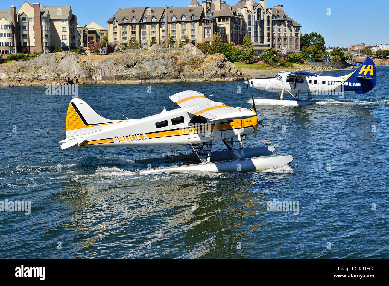 Due velivoli commuter taxi da su un altro al trafficato porto Victoria sull'Isola di Vancouver British Columbia, Canada. Foto Stock
