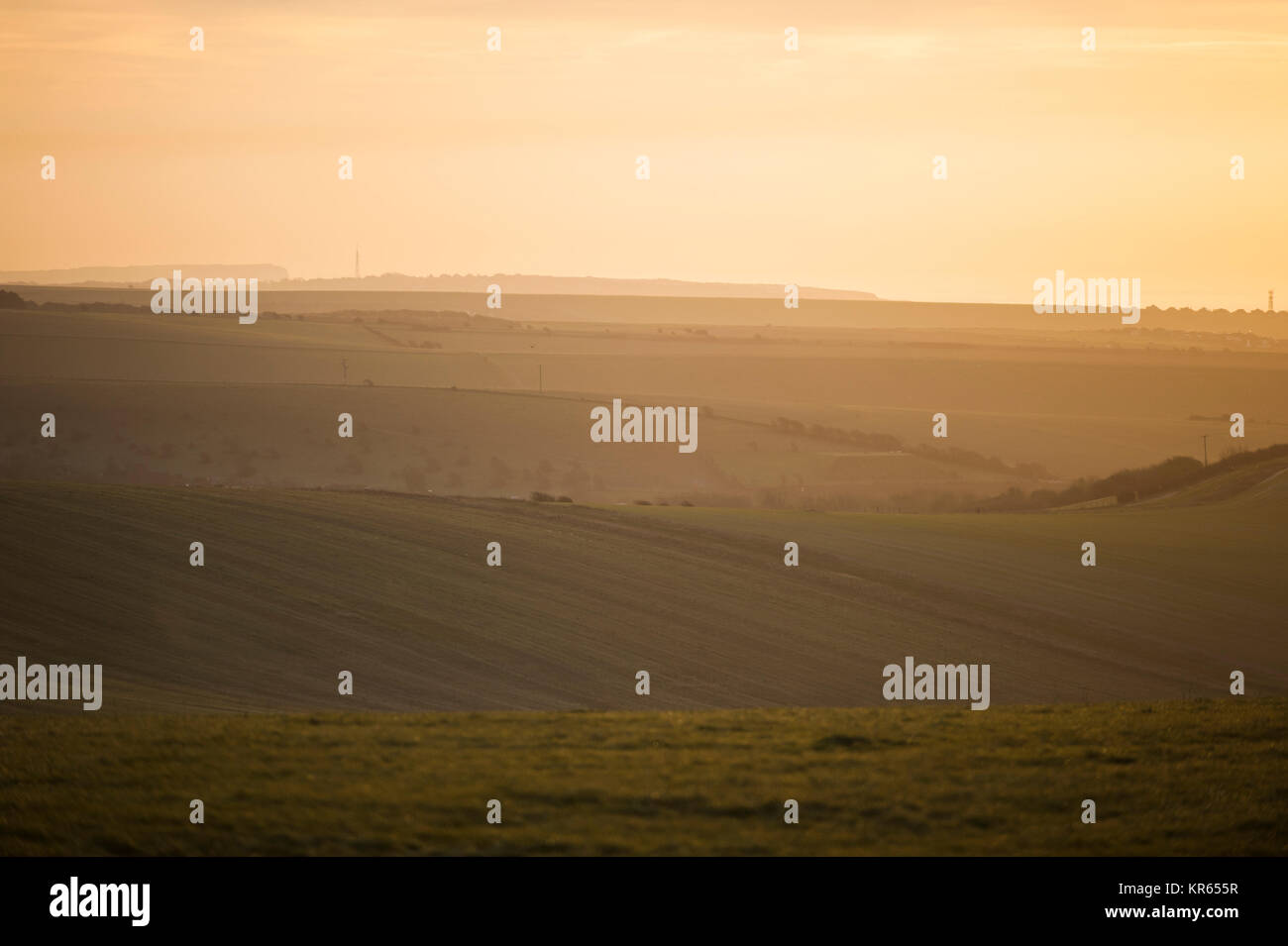 Brighton, East Sussex. 19 dicembre 2017. Regno Unito Meteo. La mattina presto dog walker e cavalieri a Brighton Racecourse e Sheepcote Valley testimonianza un incredibile tramonto sul South Downs National Park in un freddo gelido e mattina sulla costa sud. Credito: Francesca Moore/Alamy Live News Foto Stock