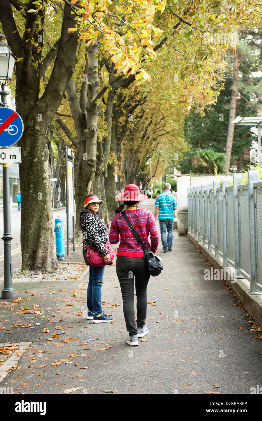 I viaggiatori di persone a piedi il sentiero accanto alla strada in small alley vai a Merano Mercatino di Natale di Merano o la città di Merano in Alto Adige, Italia Foto Stock