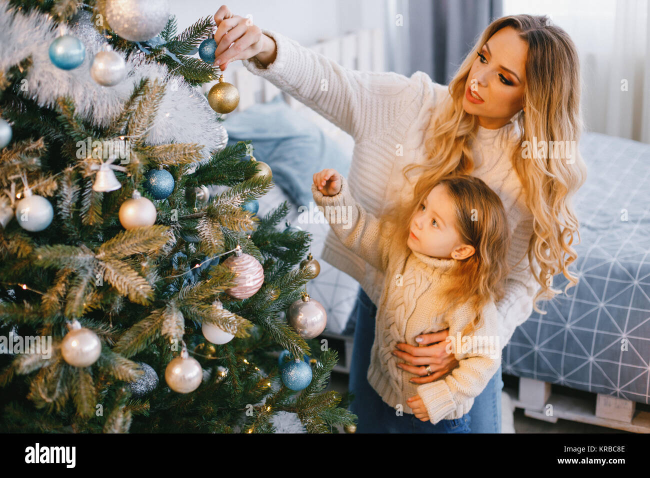 Madre e figlia decorare l'albero Foto Stock