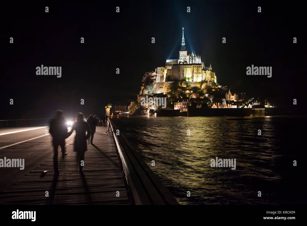 Le Mont Saint Michel (Normandia, a nord-ovest della Francia), 2015/03/22: Spring Tide di sera e walkers sulla passerella. (Non disponibile per postca Foto Stock
