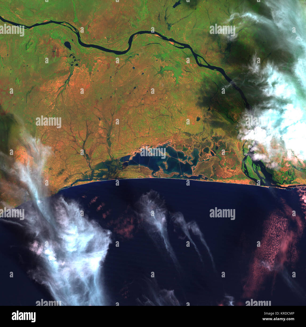 Laguna Songor, Ghana Ghana Songor laguna è un poco profondo, salmastra-laguna di acqua situato appena a ovest del fiume Volta dove si svuota nell'Oceano Atlantico in Africa occidentale la Gold Coast. L'area contiene diversi landforms e nicchie ecologiche, incluse velme, isole, aprire acqua, piccoli ruscelli, spiagge sabbiose, e saline. La laguna è un importante arresto-oltre il punto per migratori e per altre specie di uccelli. È anche sede di diverse specie di specie in pericolo o minacciate le tartarughe di mare. Questa immagine di Songor laguna dalla NASA satelliti Landsat mostra il nel dicembre 1990. Per saperne di più, ad elevata risoluzione Foto Stock