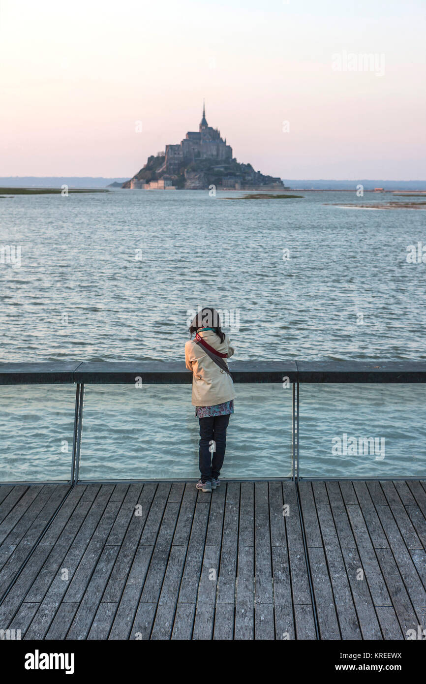 Mont Saint Michel (Saint Michael Mount), Normandia, a nord-ovest della Francia: Donna turista giapponese visto da dietro guardando Le Mont Saint Michel Foto Stock