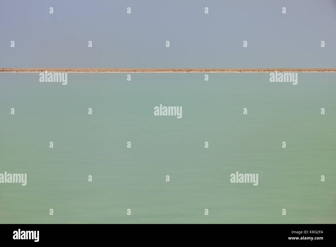 Paesaggio del mar Morto con acqua verde giallo la linea di costa e blu cielo Foto Stock