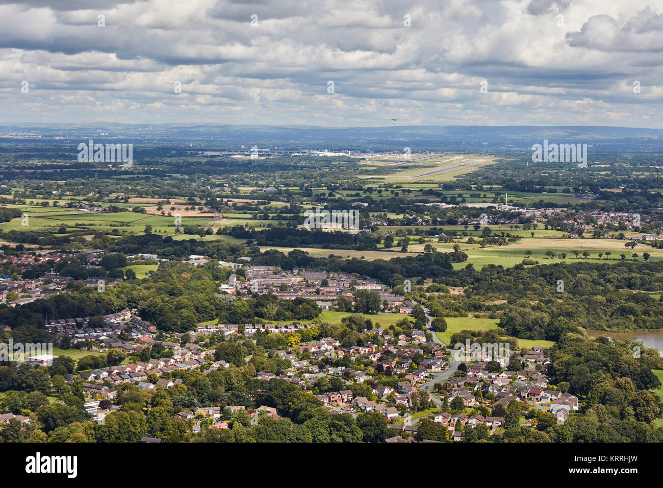 Una veduta aerea della periferia di Knutsford con l'aeroporto di Manchester in lontananza Foto Stock