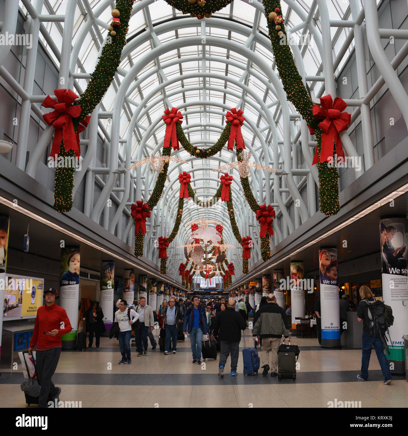Chicago, Stati Uniti d'America. L'aeroporto O'Hare, XXI Dec, 2017: volantini passare al di sotto delle decorazioni di vacanza all'O'Hare Airport all'inizio del periodo indaffarato delle feste viaggio stagione. Questo anno si prevede di impostare nuovi record di viaggio sia a Chicago Midway e O'Hare aeroporti. Credito: D Valutazione Smith/Alamy Live News Foto Stock