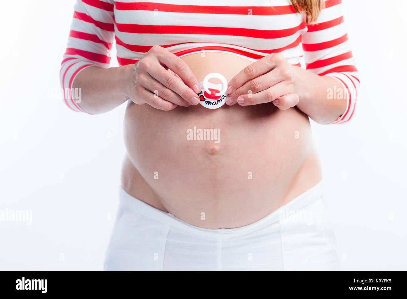 Schwangere Frau mit Schnuller am Babybauch - donna incinta con fantoccio Foto Stock