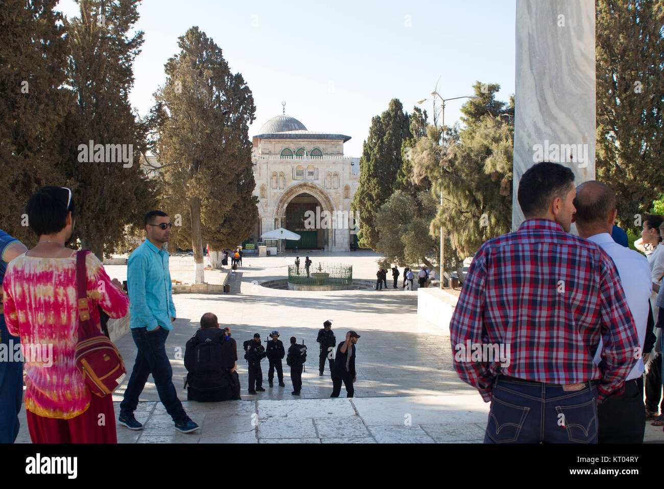 Palestinesi e turisti guarda come forze di sicurezza israeliane cordon off Moschea di Al-Aqsa per consentire adoratori ebrei a. La città vecchia di Gerusalemme Foto Stock