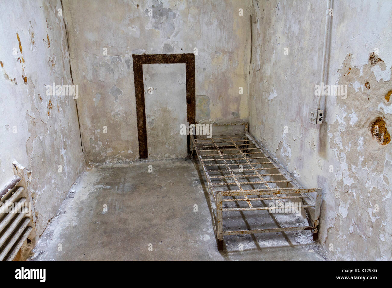 La tipica cella con letto abbandonato il telaio nella parte orientale di Stato penitenziario sito storico, Philadelphia, Stati Uniti. Foto Stock