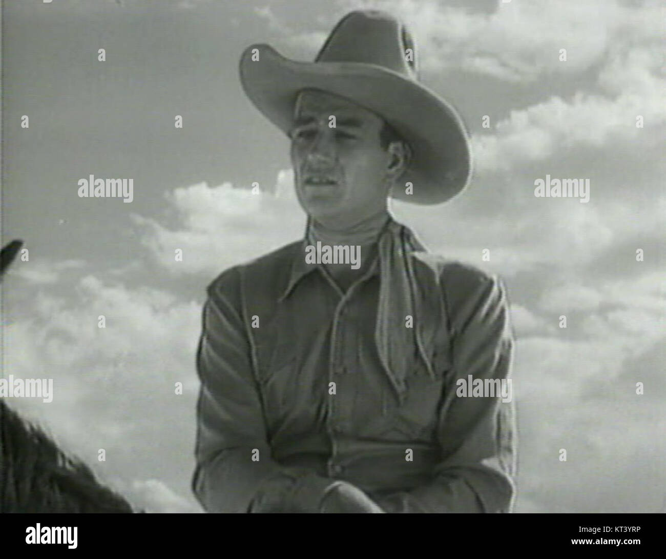 John Wayne è il protagonista del film del 1934 *The Man from Utah*, dove interpreta un cowboy forte e robusto. Il film mostra la sua prima carriera e il suo contributo al genere occidentale, evidenziando temi di giustizia ed eroismo. Foto Stock